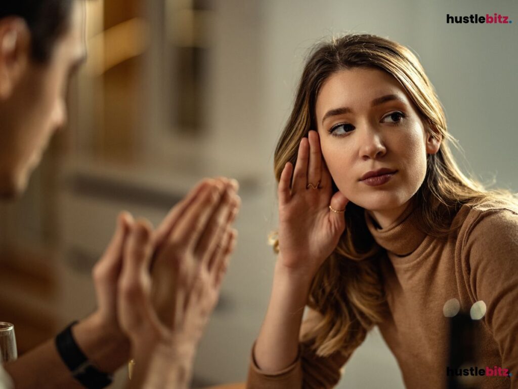 Woman listening intently while a man talks.